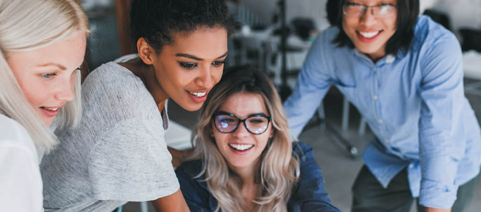 Close-up portrait of freelance it-specialists looking at laptop screen with smile  Asian programmer in glasses helping to mulatto girl in white t-shirt with her project 