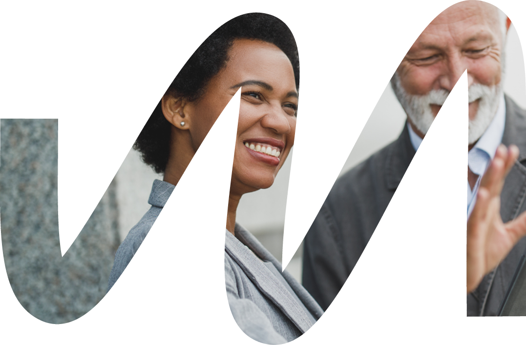 Shot of successful black businesswoman and her senior male colleague using digital tablet and having a discussion during a coffee break in front of the office building 