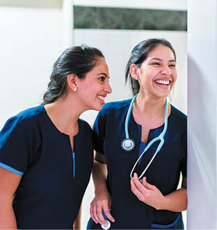 Healthcare: Happy female medical doctors in a hospital  Young medical hospital professionals, happy in healthcare facility  Copy space for text