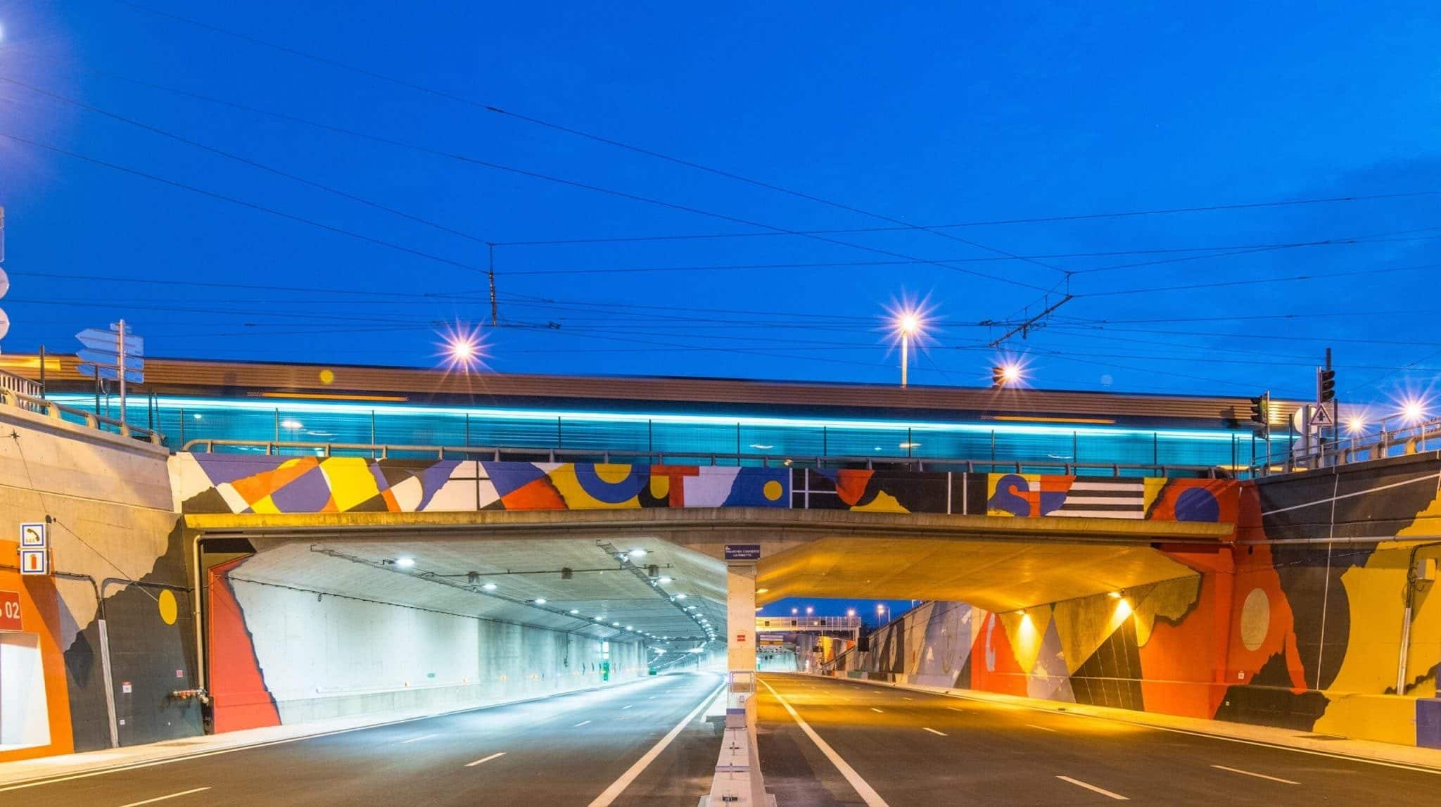 Wall murals on motorway underpass at night time