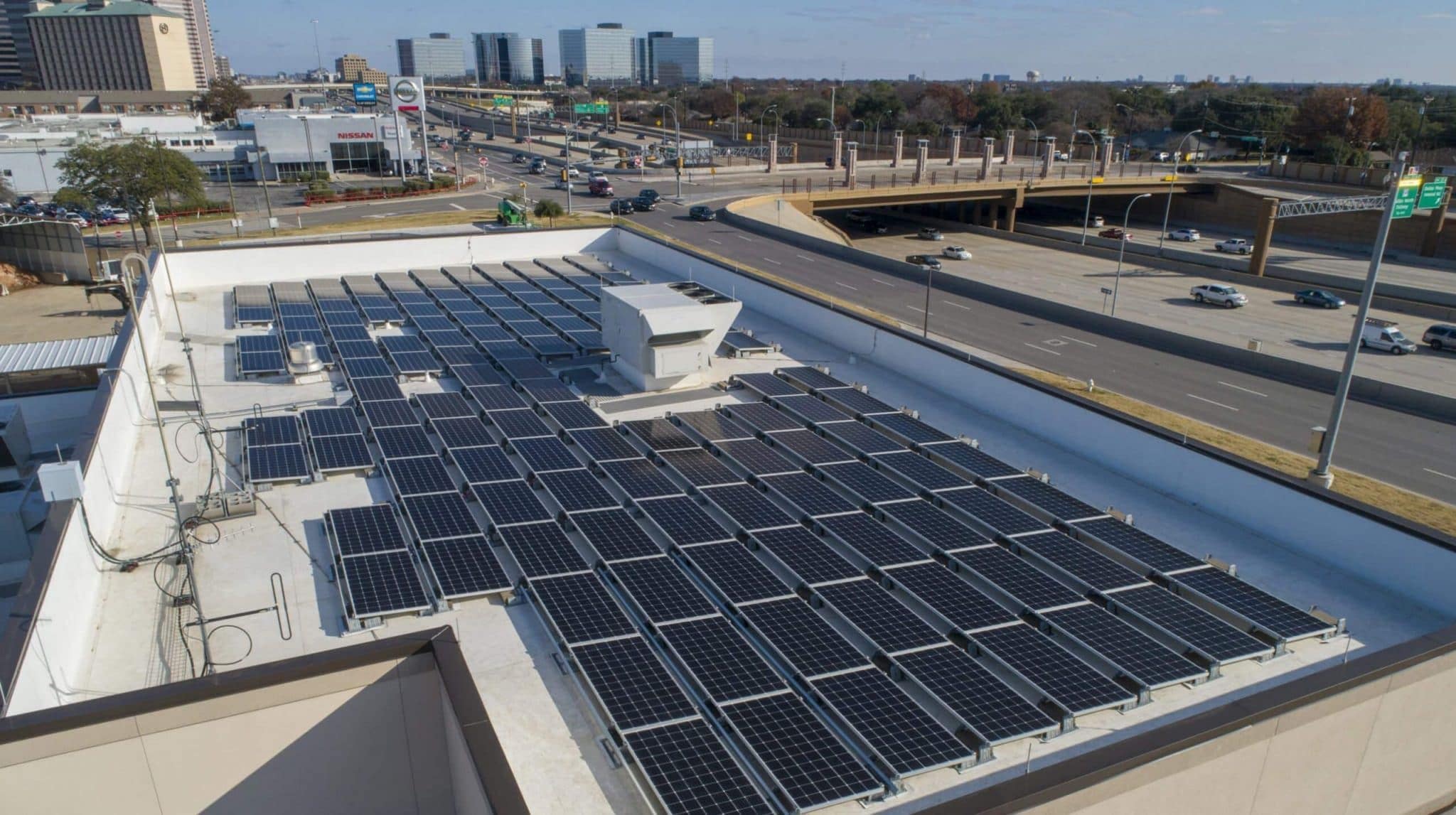 Rooftop covered with solar panels and a view of the North Tarrant Expressway