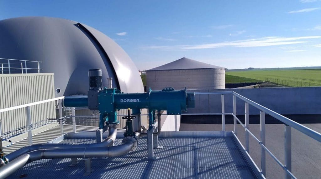 Grey biogas chamber with countryside on the right hand side