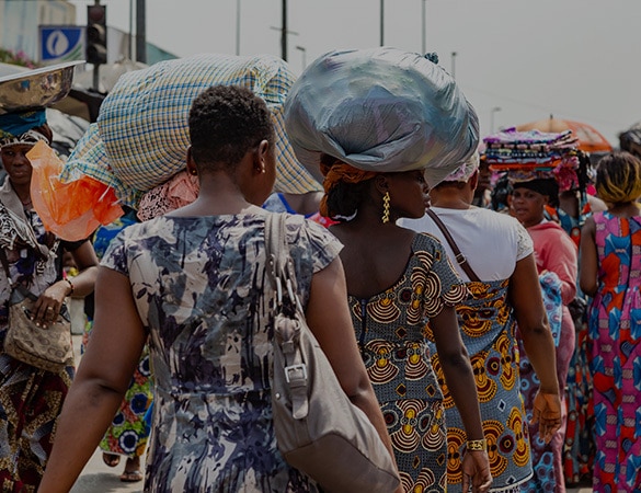 African women carrying shopping on their heads at a market