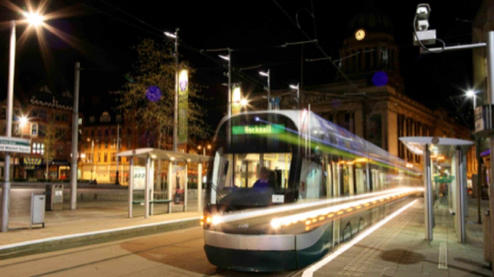 Tram in motion in Nottingham city centre at night