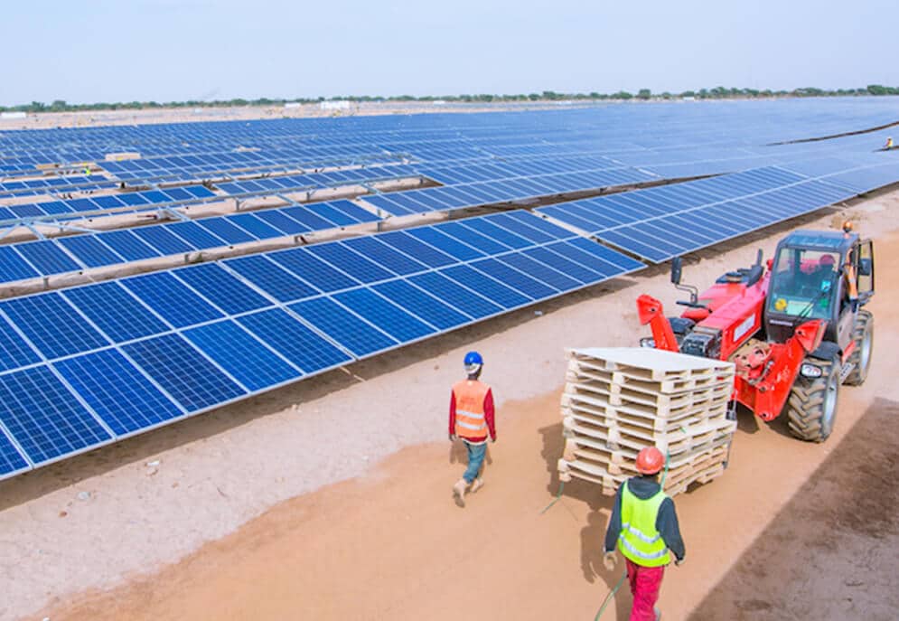 Construction workers and machinery at a solar power plant in Africa
