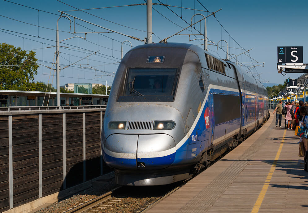 SNCF Réseau train stopped at a busy platform