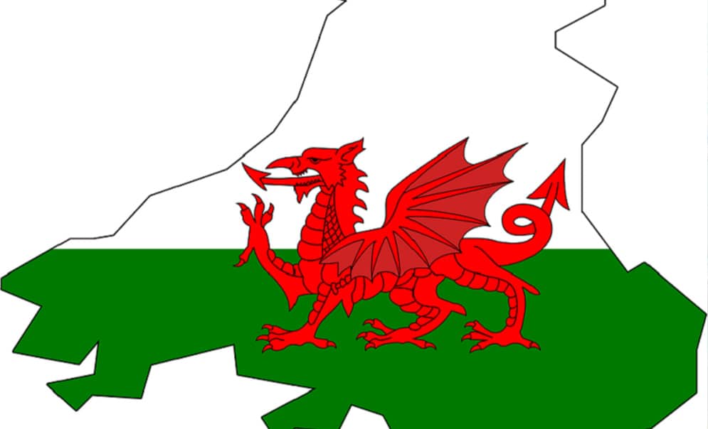 Red dragon from Welsh flag on top of outline of the country
